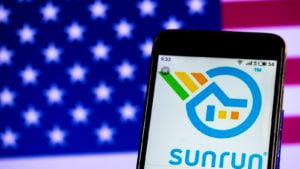 The Sunrun (RUN) logo is displayed on a smartphone screen in front of an American flag.