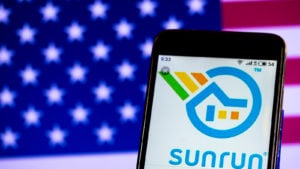 Sunrun (RUN) logo displayed on smartphone screen against American flag background.