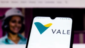 the Vale (VALE) logo displayed on a mobile phone with the company's webpage in the background