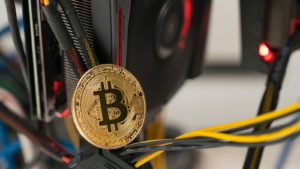 a bitcoin concept coin sitting on wires representing crypto stocks.