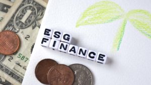 ESG Finance spelled out in letter dice near some money