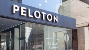 Peloton (PTON) sign on city storefront representing its stock.