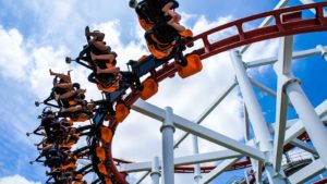 A close-up shot of a roller coaster with the blue sky in the background.