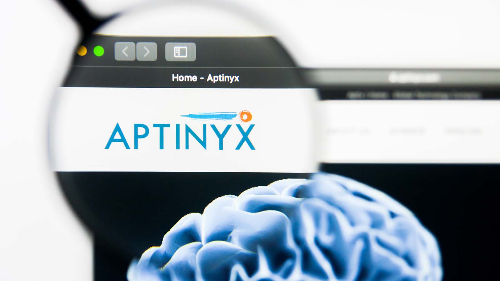 A magnifying glass zooms in on the website for Aptinyx (APTX stock).