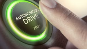 A finger hovering over an "autonomous drive" button.