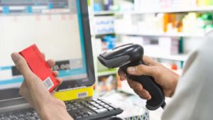 A close-up shot of a cashier using a barcode scanner. 