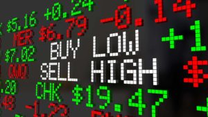 A stock market ticker tape that reads "BUY LOW SELL HIGH."