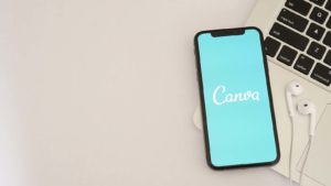 The logo for the Canva app is displayed on a smartphone screen.