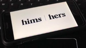 The logo for Hims & Hers (HIMS) displayed on a smartphone screen.