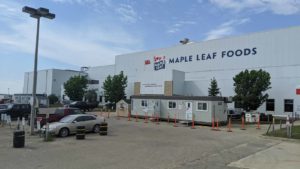 Maple Leaf Foods (MLFNF) logo on the side of one of its processing facilities.