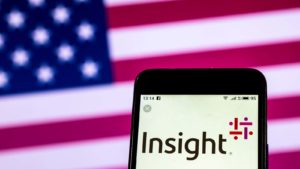 The logo for Insight Enterprises (NSIT) is displayed on a smartphone screen in front of an American flag.