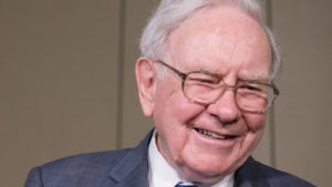 a picture of warren buffett smiling representing Warren Buffett's Annual Letter 2022.