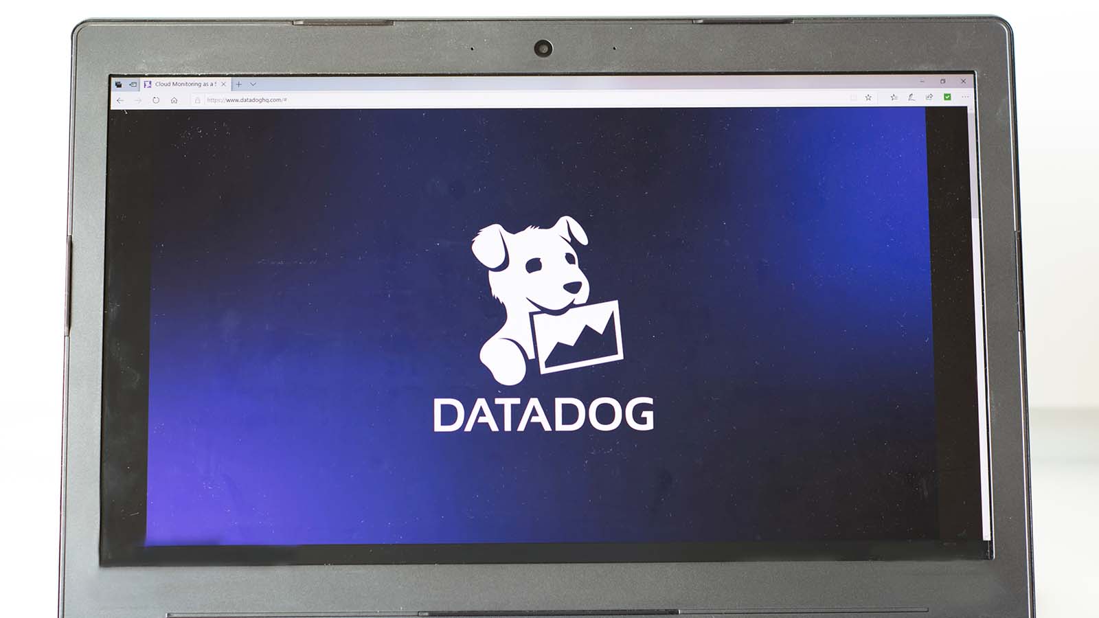 The Datadog (DDOG Stock) logo displayed on a laptop screen.