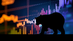 A silhouette of a bear is seen in front of an abstract stock chart.