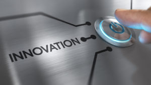 A finger hovering above a power button labeled "Innovation"