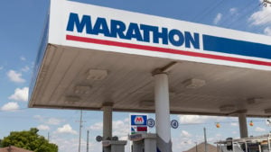 stocks to sell Marathon Oil (MRO) gas station carport on sunny day with blue sky background