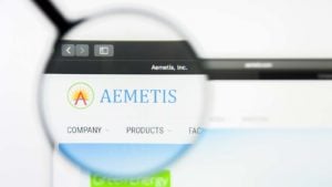 A magnifying glass zooms in on the website for Aemetis (AMTX).