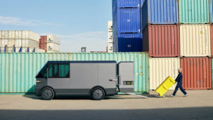 A Canoo MPDV being loaded with small shipping containers. electric vehicle stocks