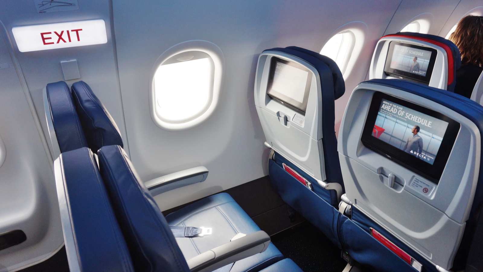 Inside the airplane cabin of a Delta flight representing airline stocks.