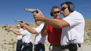 Lieutenant standing with troops holding guns on training