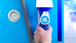 Man hold a fuel dispenser with hydrogen on gas station. h2 combustion engine for emission free eco friendly transport. Plug Power is one such company working on this power source. representing Hydrogen Stocks News