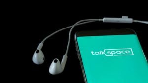 The Talkspace logo is displayed on a smartphone screen.