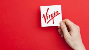 A photo of the Virgin logo on white against a red background.