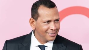 A close-up shot of Alex Rodriguez against a pink background.