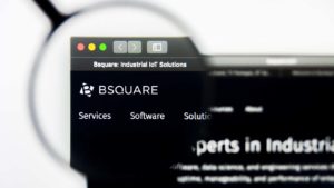 A magnifying glass zooms in on the website for BSQUARE (BSQR).