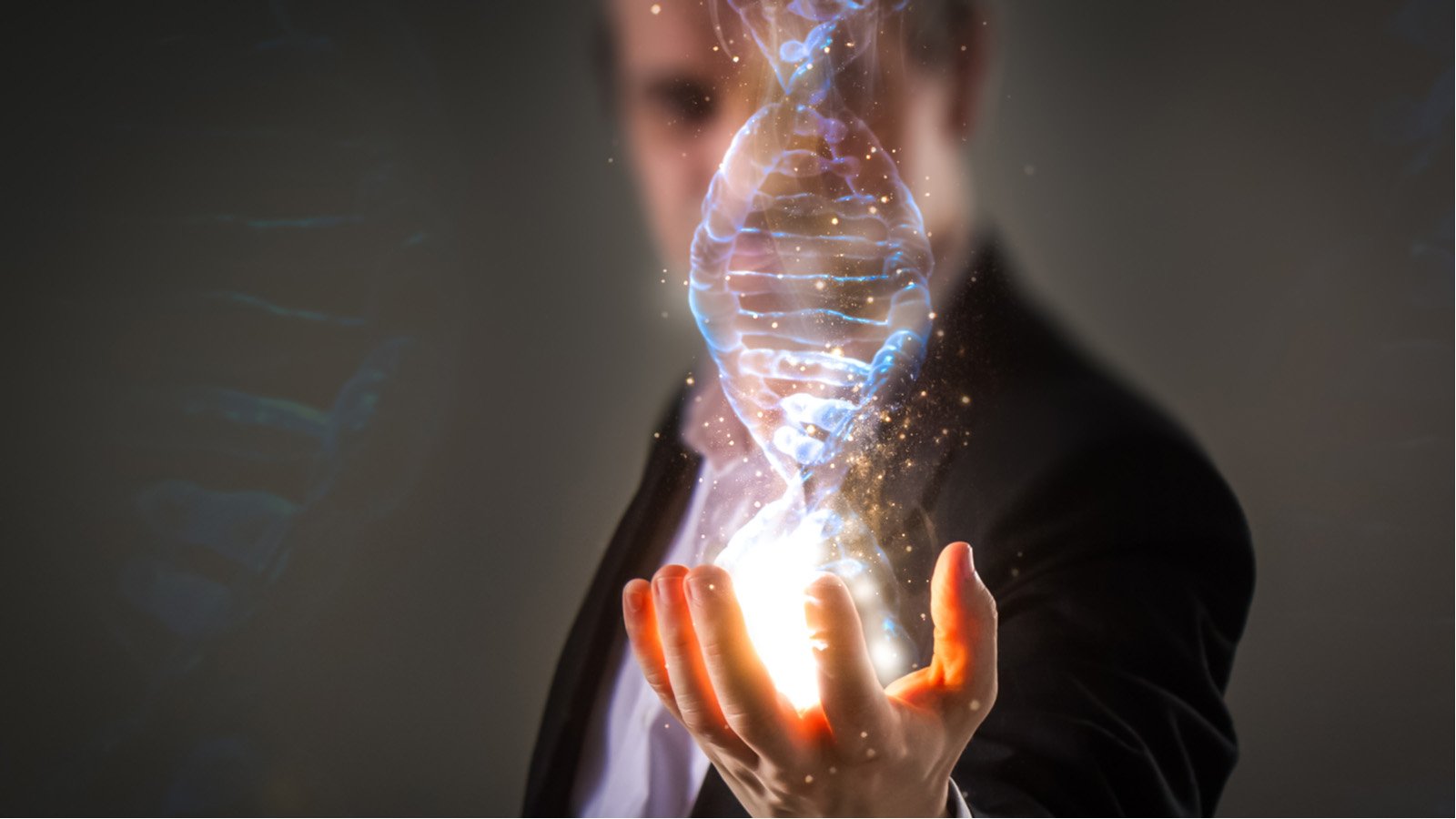 close up of Businessman holding glowing DNA helix with energy sparks representing NTLA Stock.