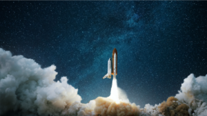 Image of space shuttle blasting off against starry backdrop, smoke plumes underneath shuttle; space stock