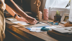 Image of a person doing crafts on a table.