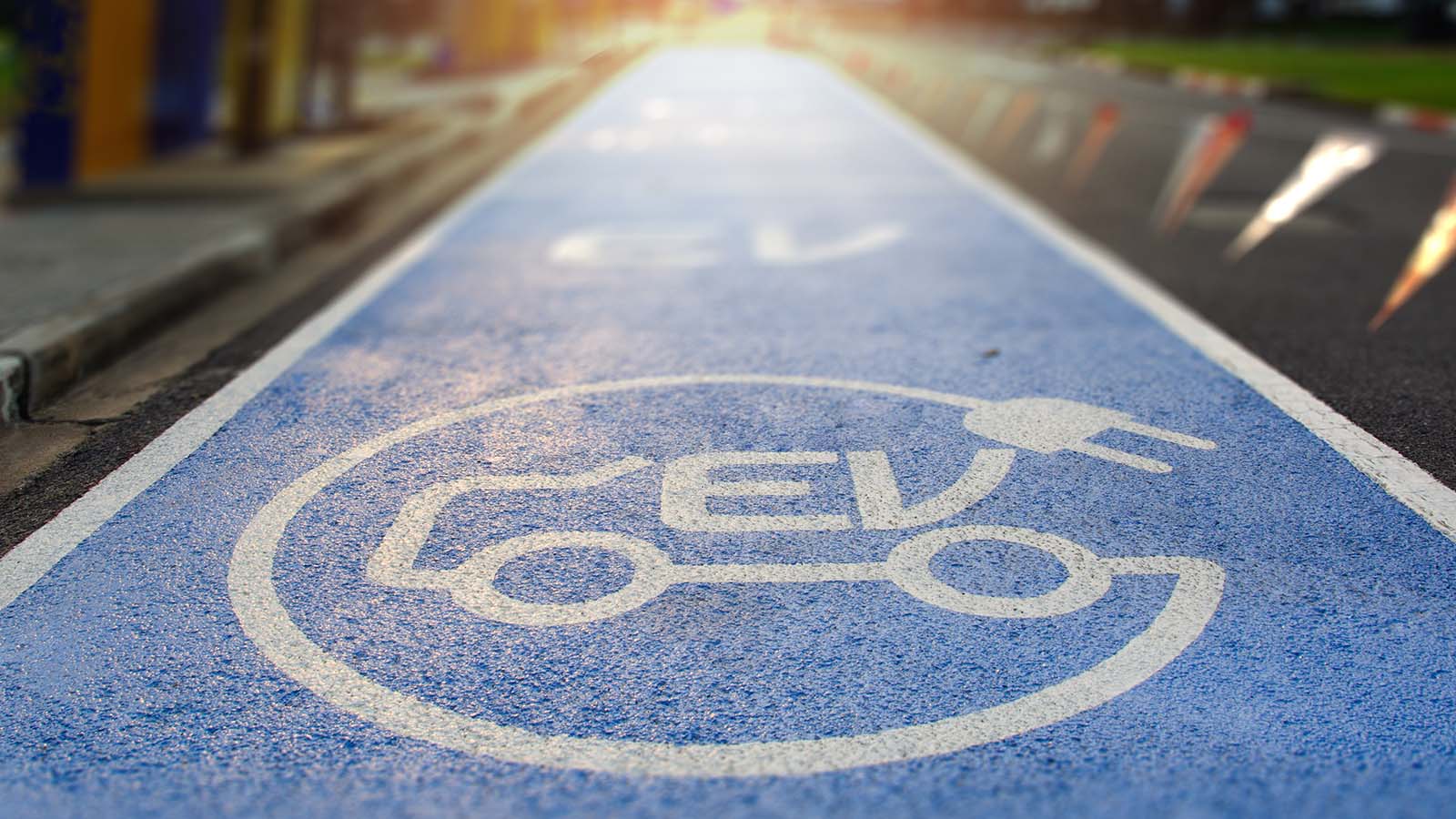 Electric vehicle logo painted on a blue street