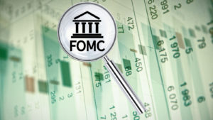 Magnifying lens over background with building icon and text FOMC, with the financial data visible in the background. 3D rendering.