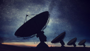 space SPACs Silhouettes of satellite dishes or radio antennas against night sky