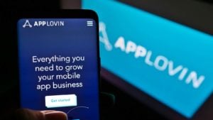 The AppLovin (APP) info on an iPhone and laptop screen.
