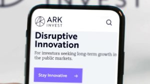 A close-up of the Ark Invest homepage on a smartphone screen.