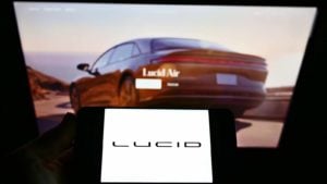 The Lucid Motors (CCIV) logo is displayed in front of an ad for the Air sedan. 