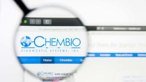 A magnifying glass zooms in on the website for Chembio Diagnostics (CEMI).