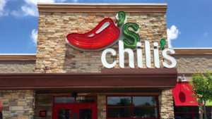 A photograph of a Chili's restaurant sign owned by Brinter International (EAT).