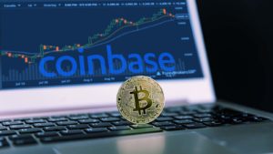 Bitcoin is located on top of a computer with the Coinbase (COIN) logo and a trading chart.