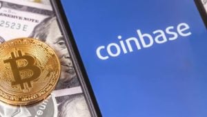 The Coinbase logo on a smartphone screen with a BTC token. Crypto winter is setting in.