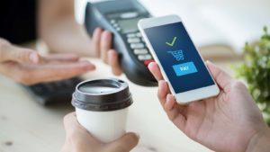 A concept image of mobile payment with a smart phone for a cup of coffee. affordable payment stocks