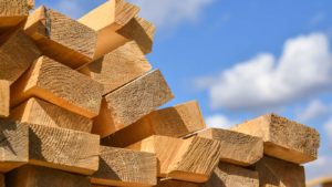 A stack of lumber with a blue sky in the background.