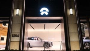 A shot from the outside of a Nio (NIO) display room at night.