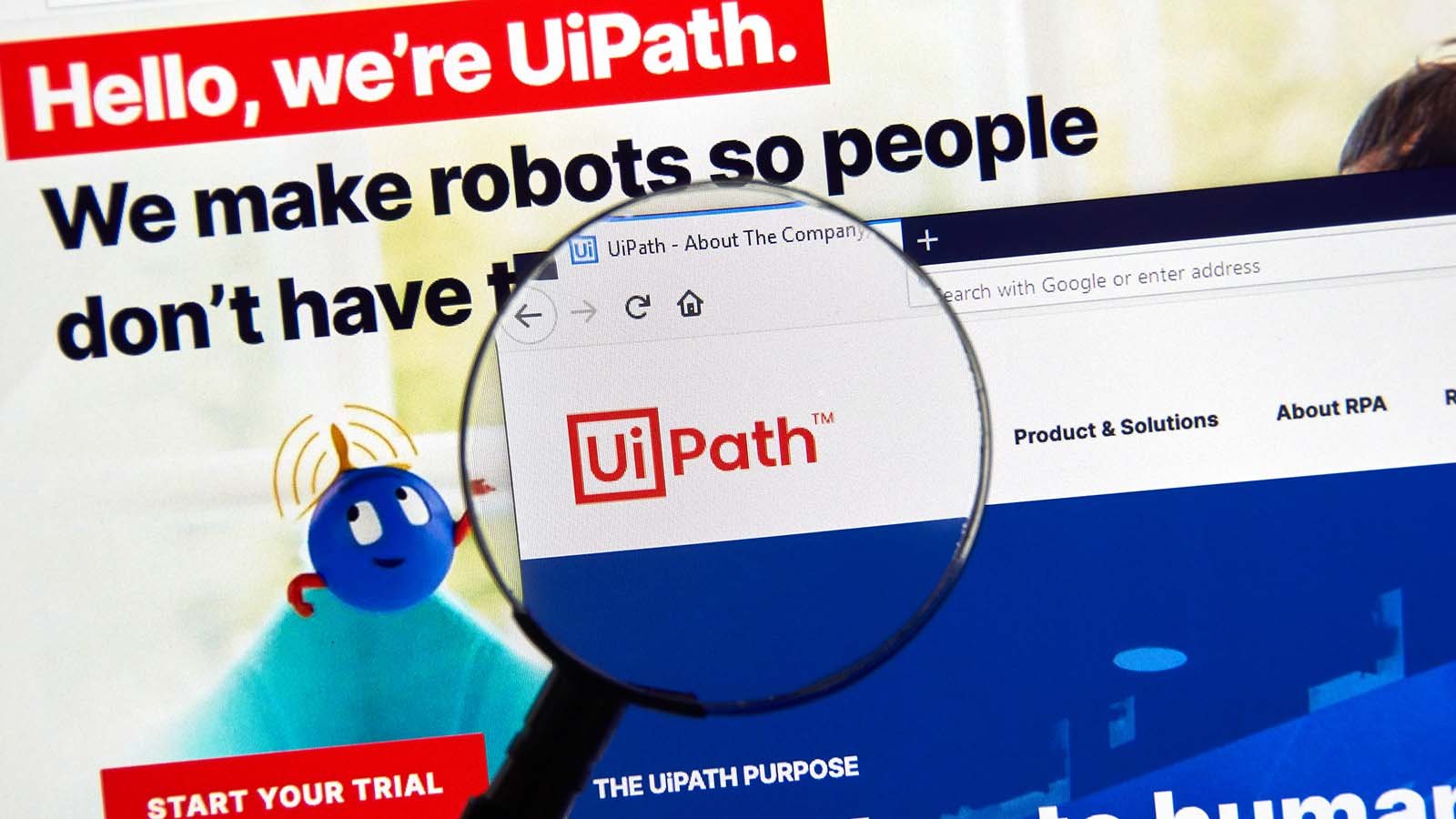 A magnifying glass zooms in on the website homepage of UiPath (PATH).
