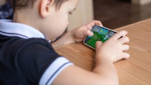 A child playing Roblox on a smartphone.