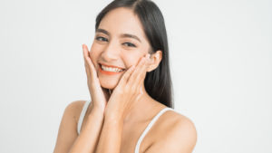 woman smiling with white background representing PTE stock.