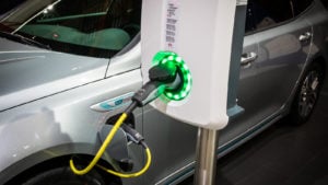 EVBox charger charging a Kia Optima SW plug-in hybrid car at the Brussels Autosalon Motor Show.