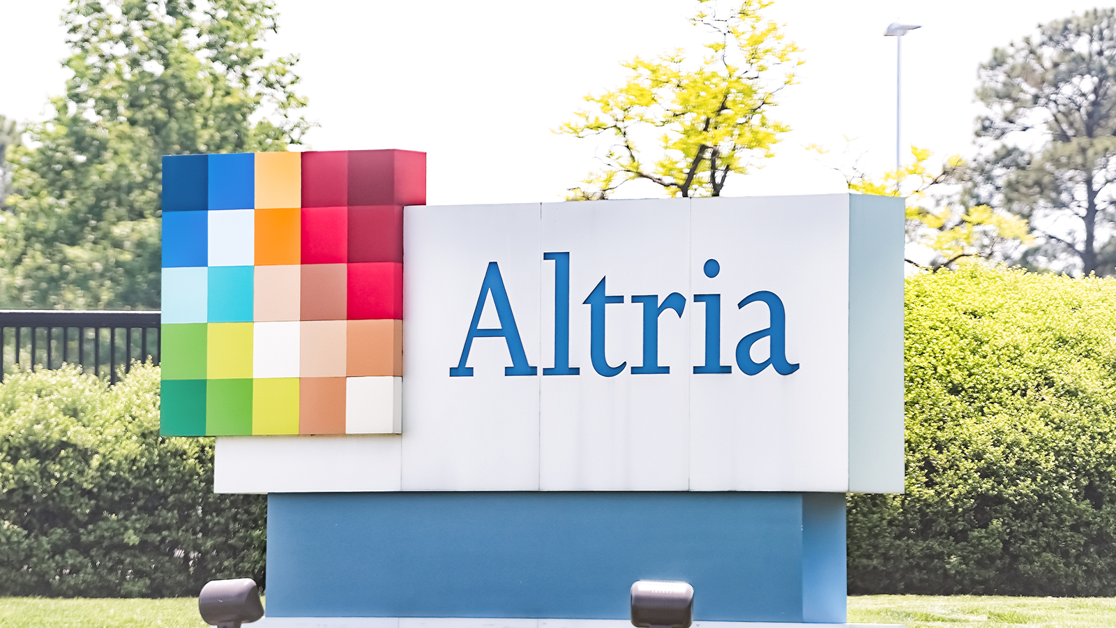 Altria office sign in Virginia capital city tobacco business closeup by road street representing MO stock.